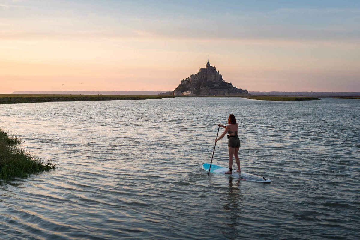In action shot of a SUP touring session on a SIC Maui stand up paddleboard near Mont Saint-Michel during sunset.