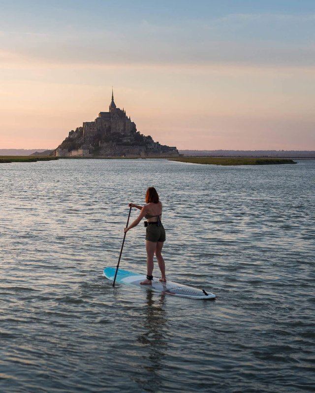 In action shot of a SUP touring session on a SIC Maui stand up paddleboard near Mont Saint-Michel during sunset.