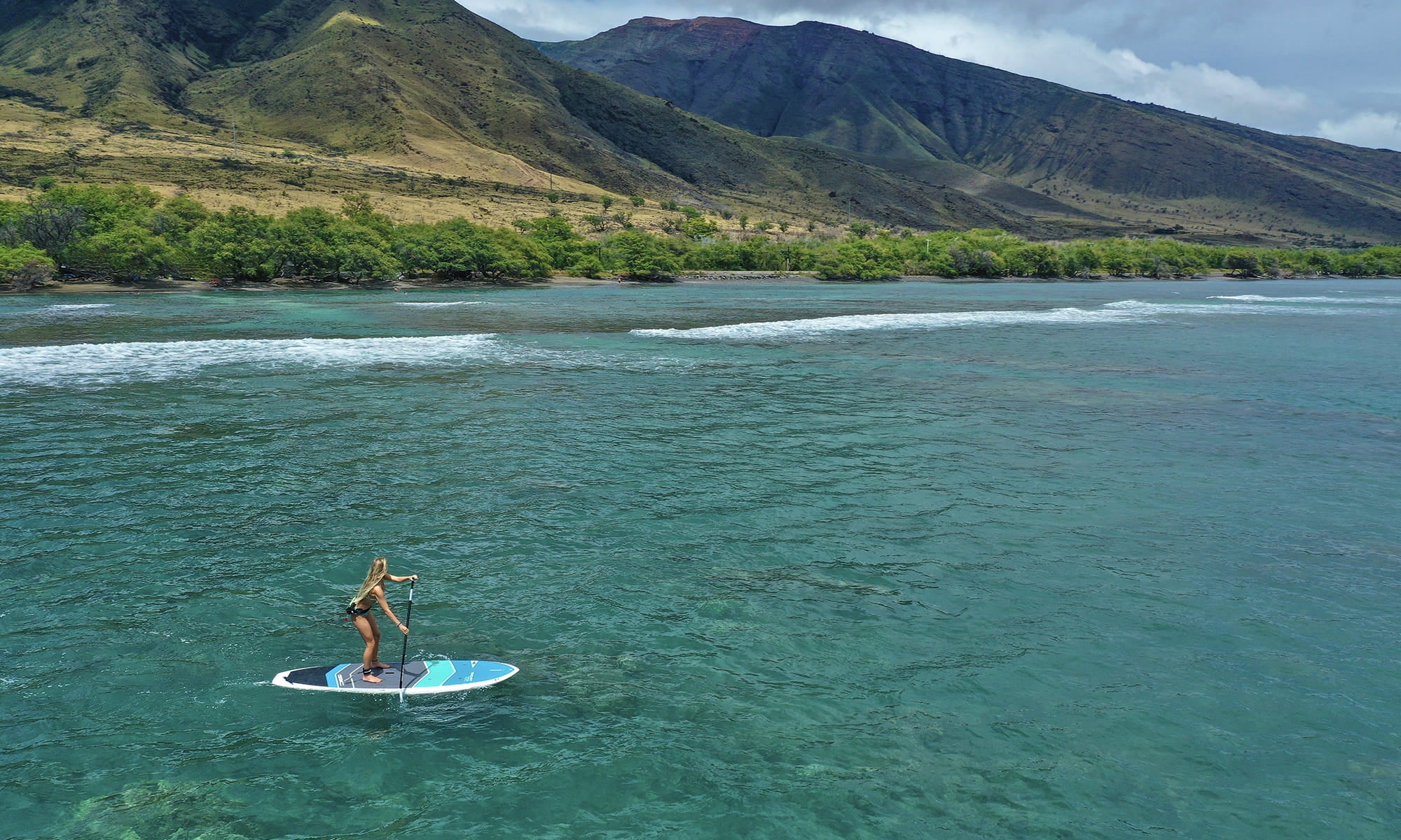 Paddler in action on a SIC Maui stand up paddleboard during an ocean session.