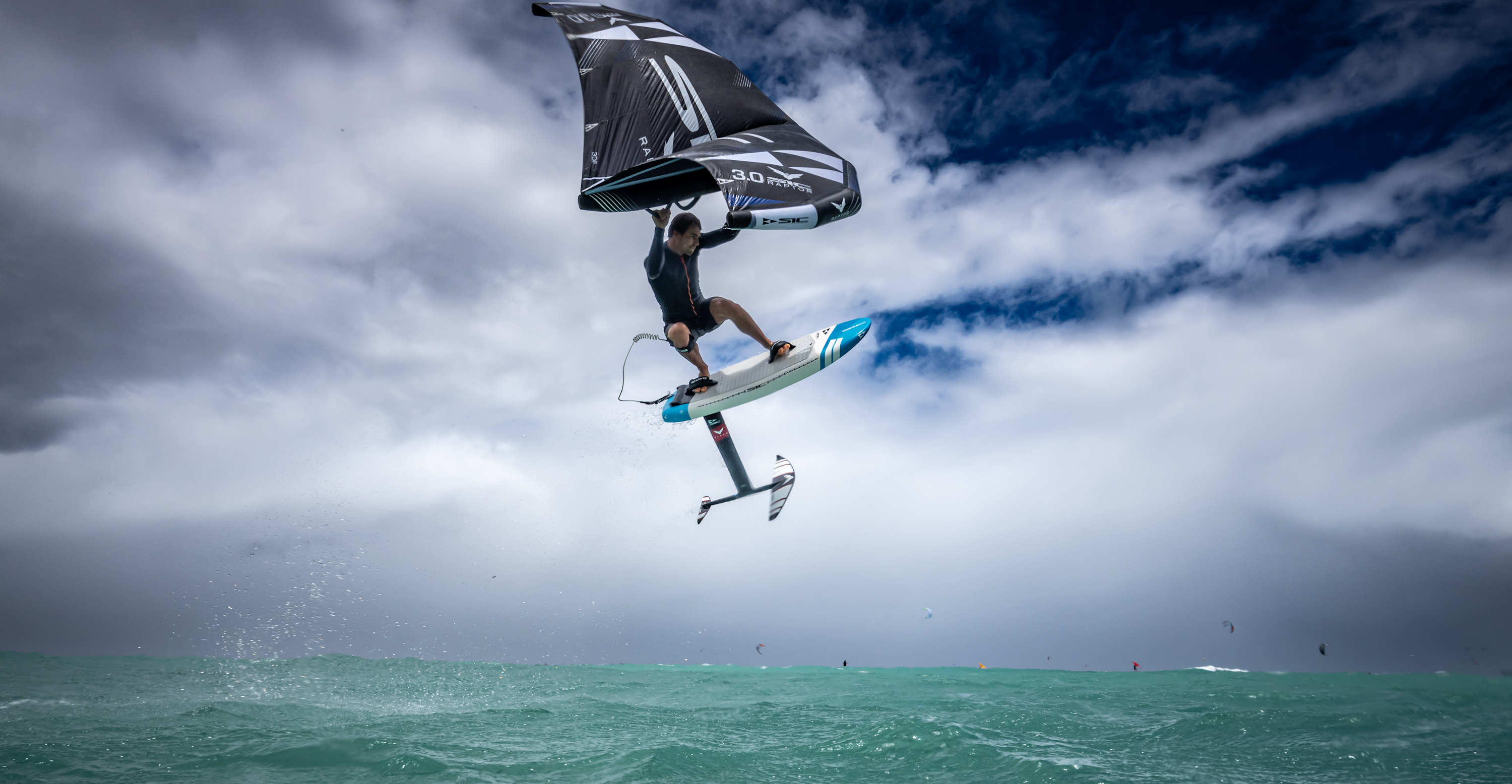 wing surfer flying